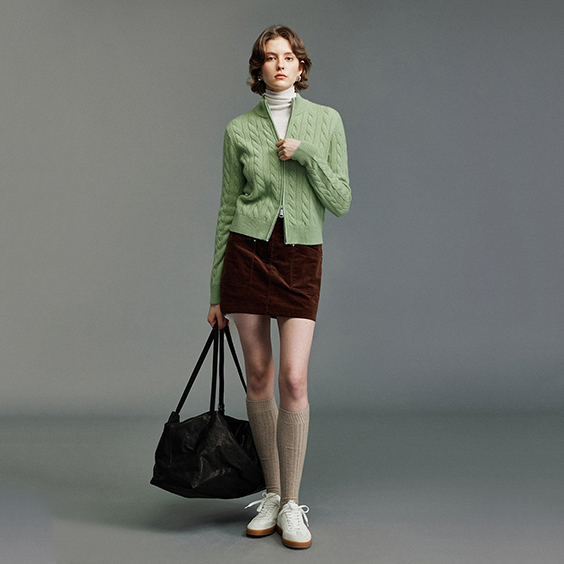 Women's cable knit cashmere cardigan worn for autumn winter layering